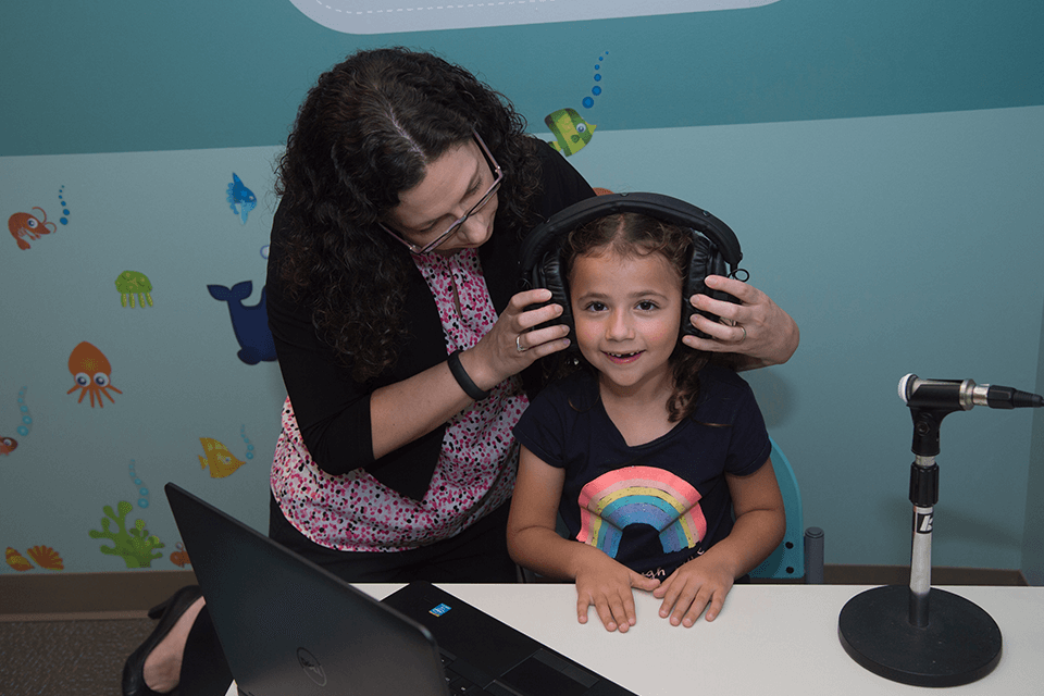 Faculty testing child's hearing
