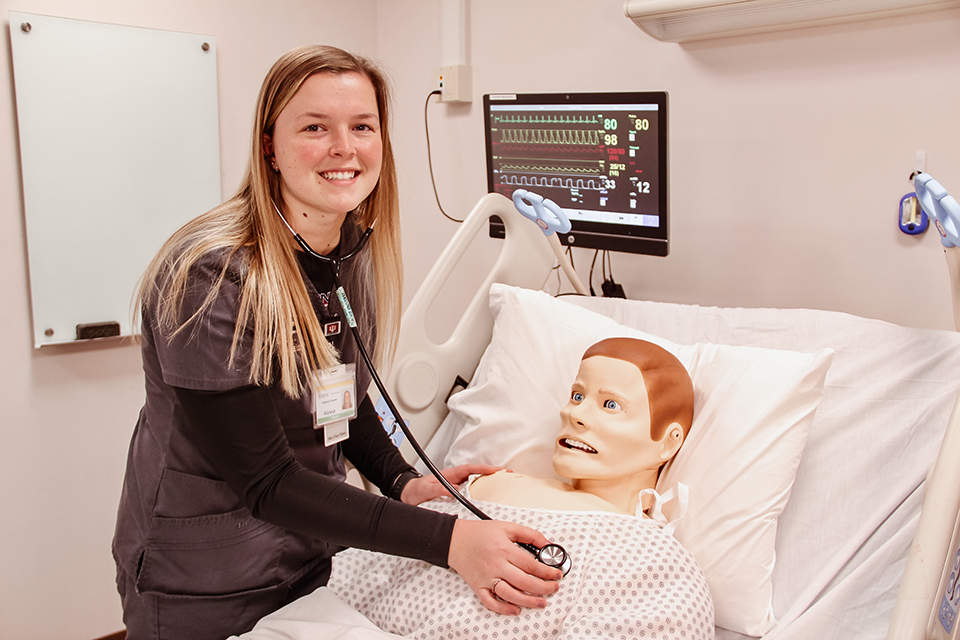 Nursing student with simulator