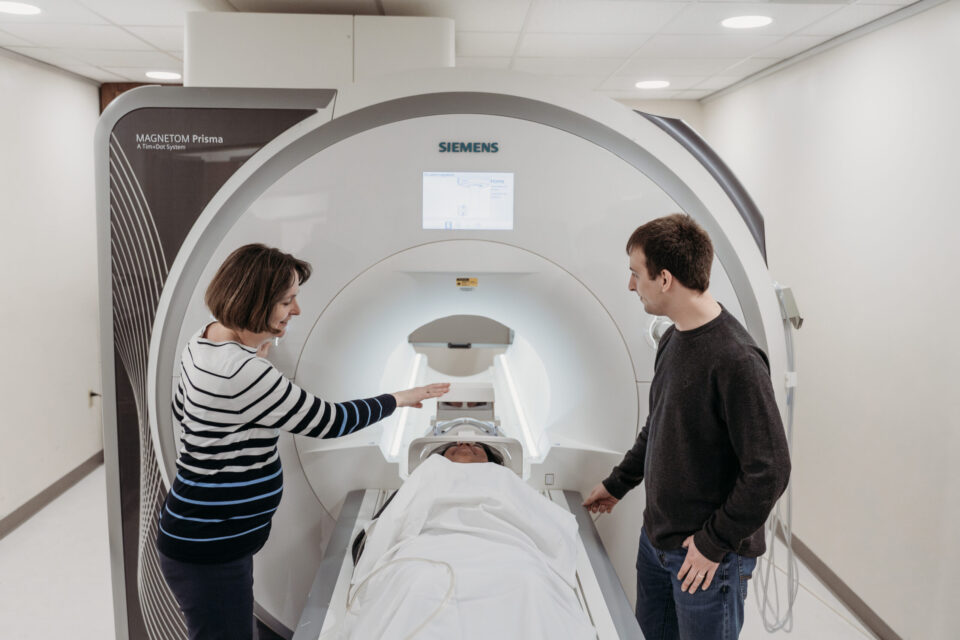 Instructor discussing the procedure for an MRI scan to a student.