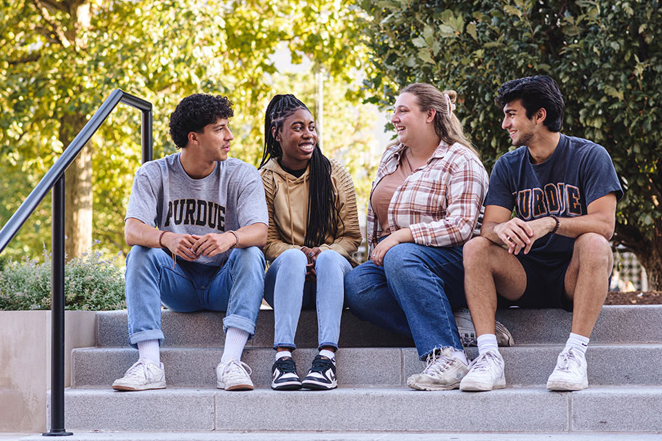 Students sitting on steps on campus.