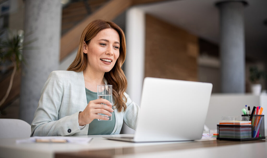 Successful businesswoman using laptop, working in office. Business technology corporate concept