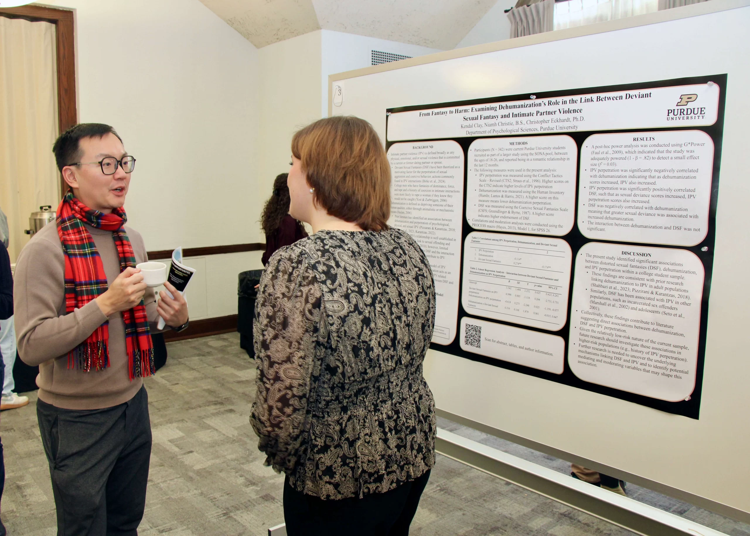 Demonstrator talking to Franki Kung about their poster.