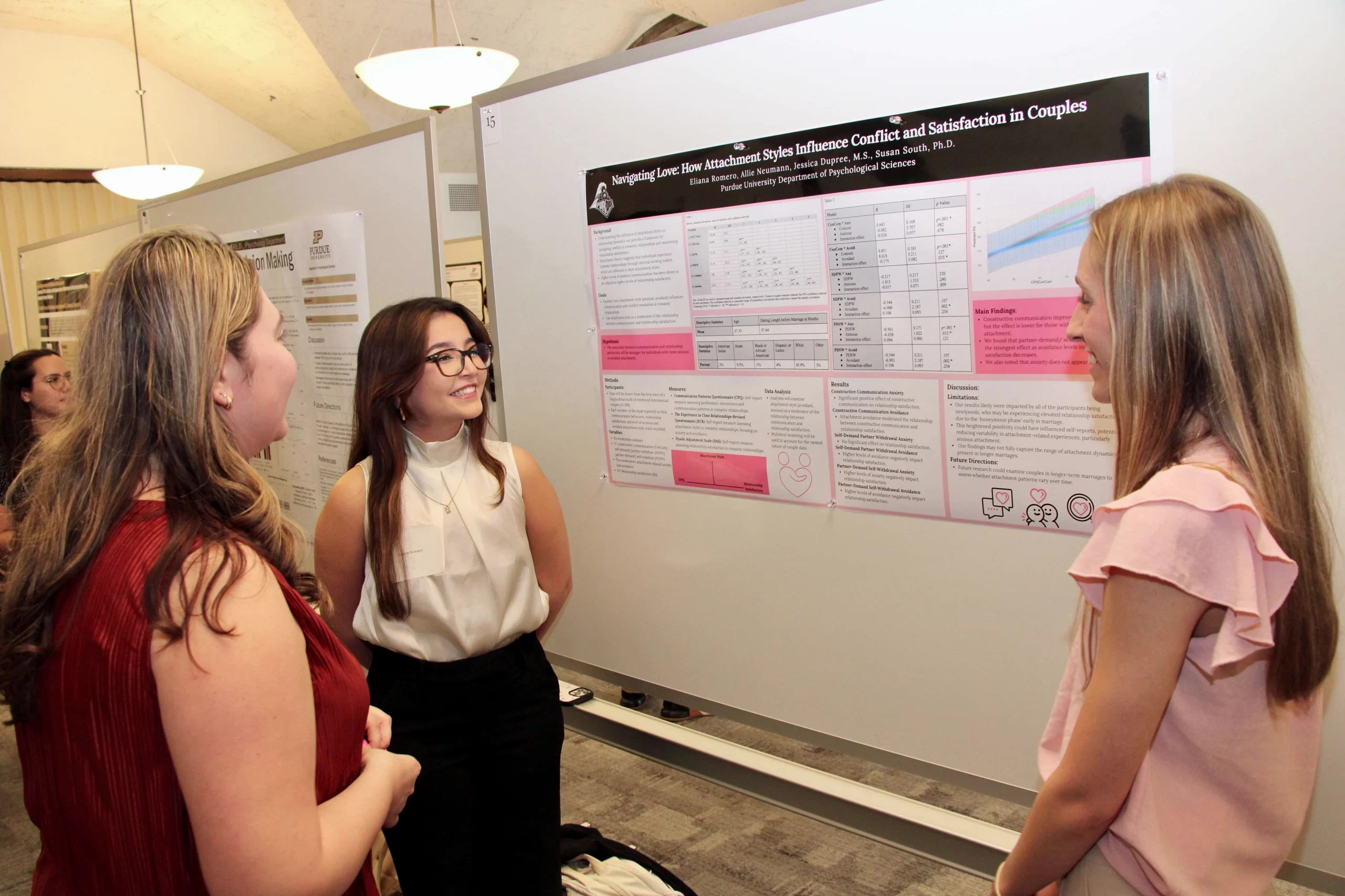 Eliana engaging two other people about the contents on her poster.