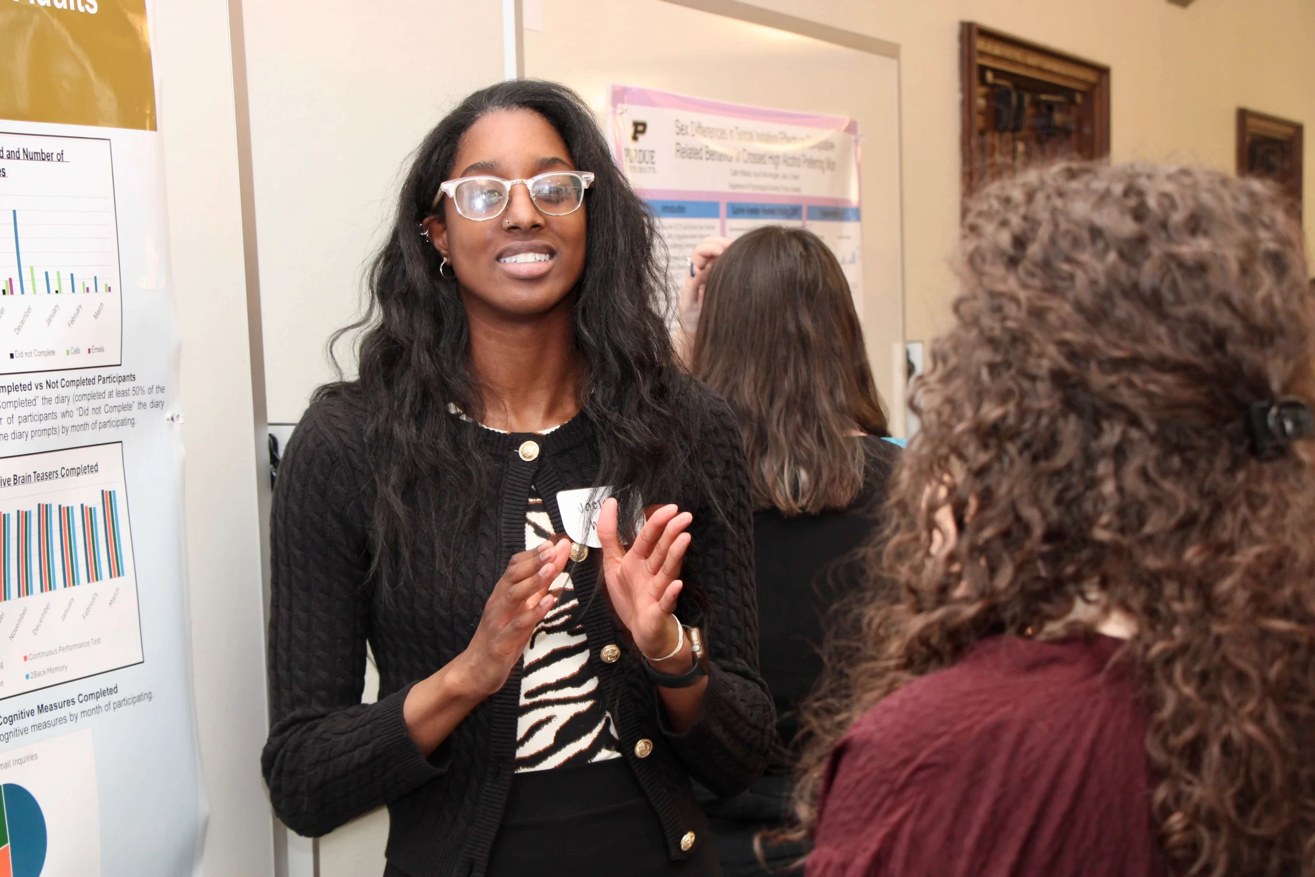 Student demonstrating poster content.