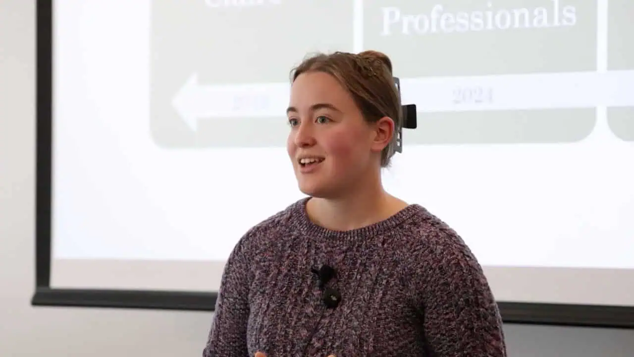 Abby Honegger’s Say It BIG 2025 second-place project slide featuring a student timeline graphic with Skills for Helping Professionals coursework and experiential learning development.