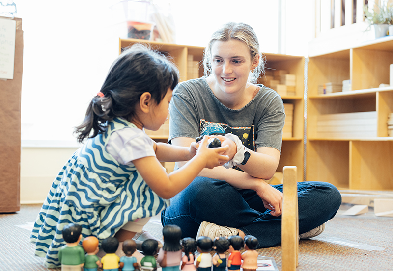 Student with child in pre-school classroom